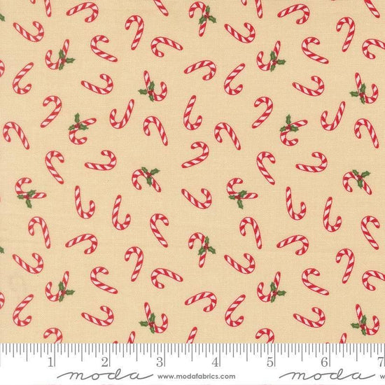 Image of Holiday Cheer Candy Cane Natural quilting cotton fabric by Stacy Iest Hsu for Moda Fabrics. Features candy canes on a cream background. Cute Little Fabric Shop.
