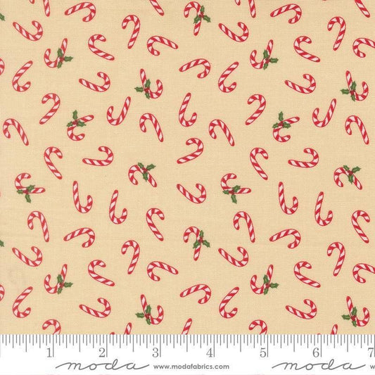 Image of Holiday Cheer Candy Cane Natural quilting cotton fabric by Stacy Iest Hsu for Moda Fabrics. Features candy canes on a cream background. Cute Little Fabric Shop.