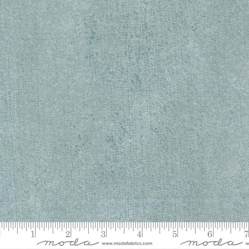 Image of Chilly White Out Storm quilting cotton fabric by Sweetwater for Moda Fabrics. Features printed texture on a blue background. Cute Little Fabric Shop.