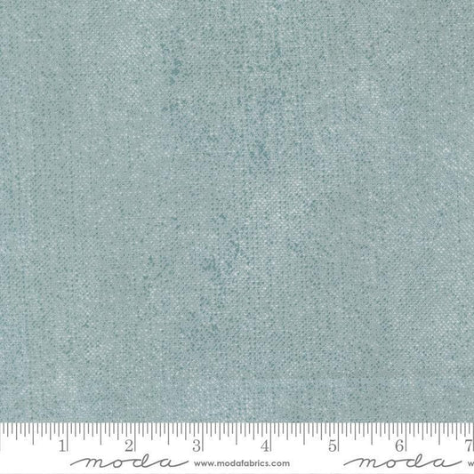 Image of Chilly White Out Storm quilting cotton fabric by Sweetwater for Moda Fabrics. Features printed texture on a blue background. Cute Little Fabric Shop.