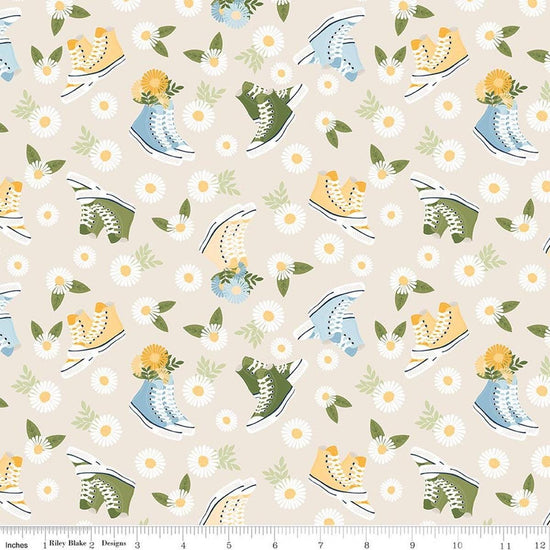 Image of Sunshine & Dandelions Shoes Cream quilting cotton fabric by Traci Reed for Riley Blake Designs. Features flowers and shoes on a cream background. Cute Little Fabric Shop.