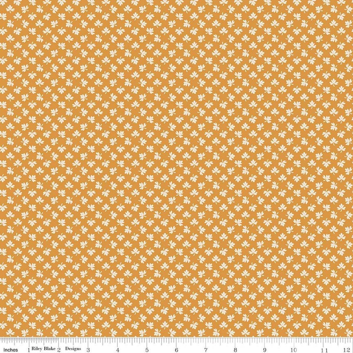 Image of Baked With Love Gathering Spice quilting cotton fabric by Lori Holt for Riley Blake Designs. Features leaves on an orange background. Cute Little Fabric Shop.