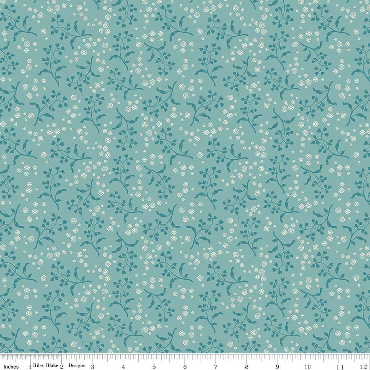Image of Baked With Love Apron Wedgewood quilting cotton fabric by Lori Holt for Riley Blake Designs. Features flowers on a blue background. Cute Little Fabric Shop.