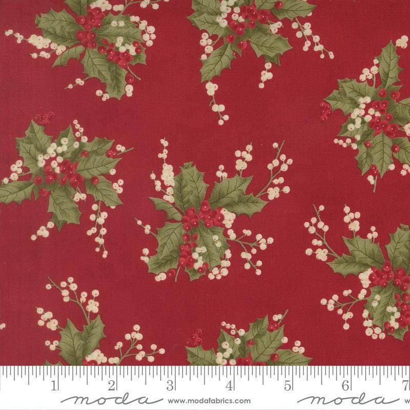 Image of Candlelight Christmas Holly Berry Crimson quilting cotton fabric by 3 Sisters for Moda Fabrics. Features leaves and berries on a red background. Cute Little Fabric Shop.