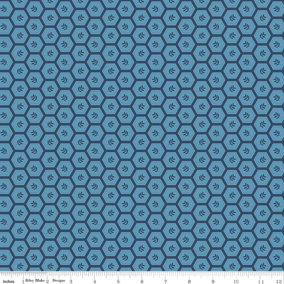 Image of Sunshine & Dandelions Hexies Blue quilting cotton fabric by Traci Reed for Riley Blake Designs. Features a geometric pattern on a blue background. Cute Little Fabric Shop.