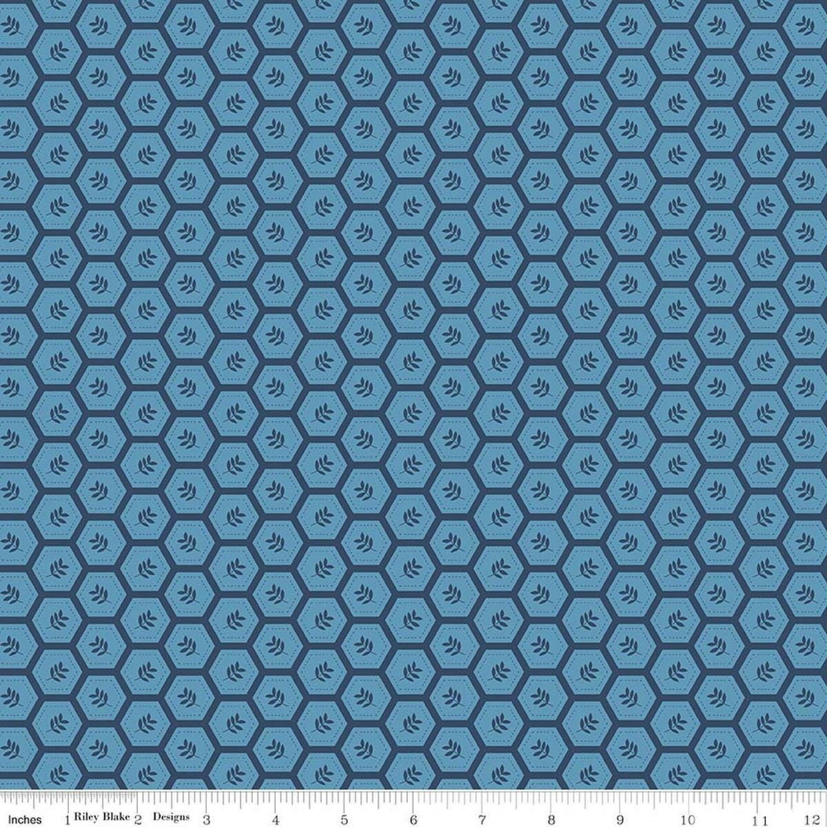 Image of Sunshine & Dandelions Hexies Blue quilting cotton fabric by Traci Reed for Riley Blake Designs. Features a geometric pattern on a blue background. Cute Little Fabric Shop.