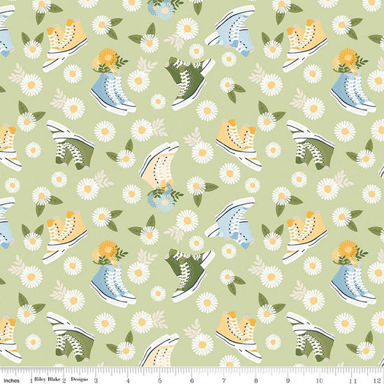 Image of Sunshine & Dandelions Shoes Honeydew quilting cotton fabric by Traci Reed for Riley Blake Designs. Features flowers and shoes on a green background. Cute Little Fabric Shop.