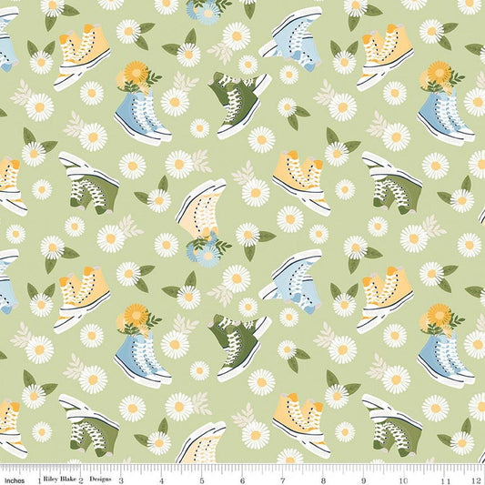 Image of Sunshine & Dandelions Shoes Honeydew quilting cotton fabric by Traci Reed for Riley Blake Designs. Features flowers and shoes on a green background. Cute Little Fabric Shop.