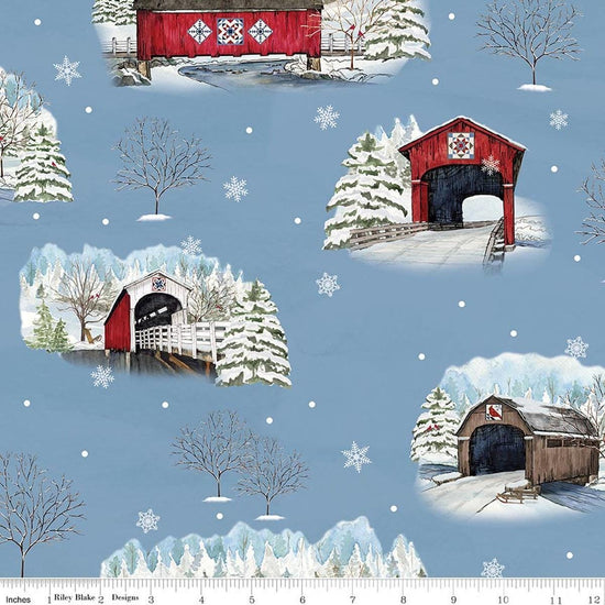 Image of Covered Bridges in Winter Main Blue quilting cotton fabric by Tara Reed for Riley Blake Designs. Features trees on a blue background. Cute Little Fabric Shop.