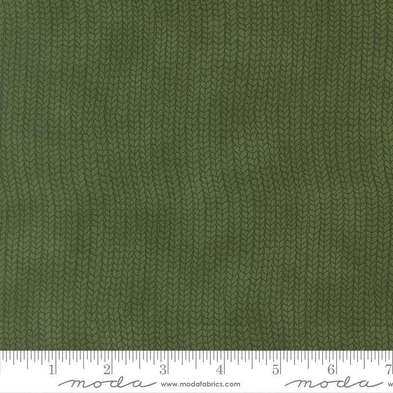 Image of When Snow Falls Stocking Weave Holly quilting cotton fabric by Deb Strain for Moda Fabrics. Features printed tonal knitting texture on a green background. Cute Little Fabric Shop.