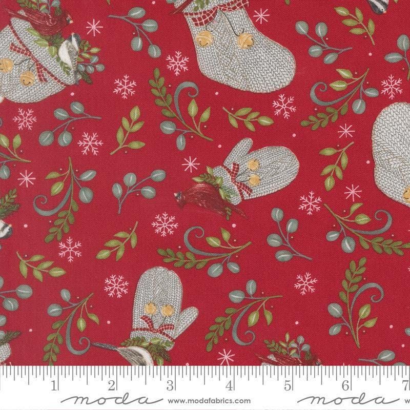 Image of When Snow Falls Winter Wear Berry Red quilting cotton fabric by Deb Strain for Moda Fabrics. Features stockings, mittens, and leaves on a red background. Cute Little Fabric Shop.