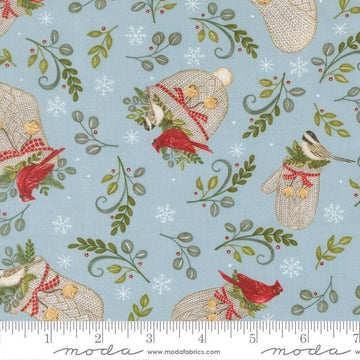 Image of When Snow Falls Winter Wear Winter Sky quilting cotton fabric by Deb Strain for Moda Fabrics. Features stockings, mittens, and leaves on a blue background. Cute Little Fabric Shop.