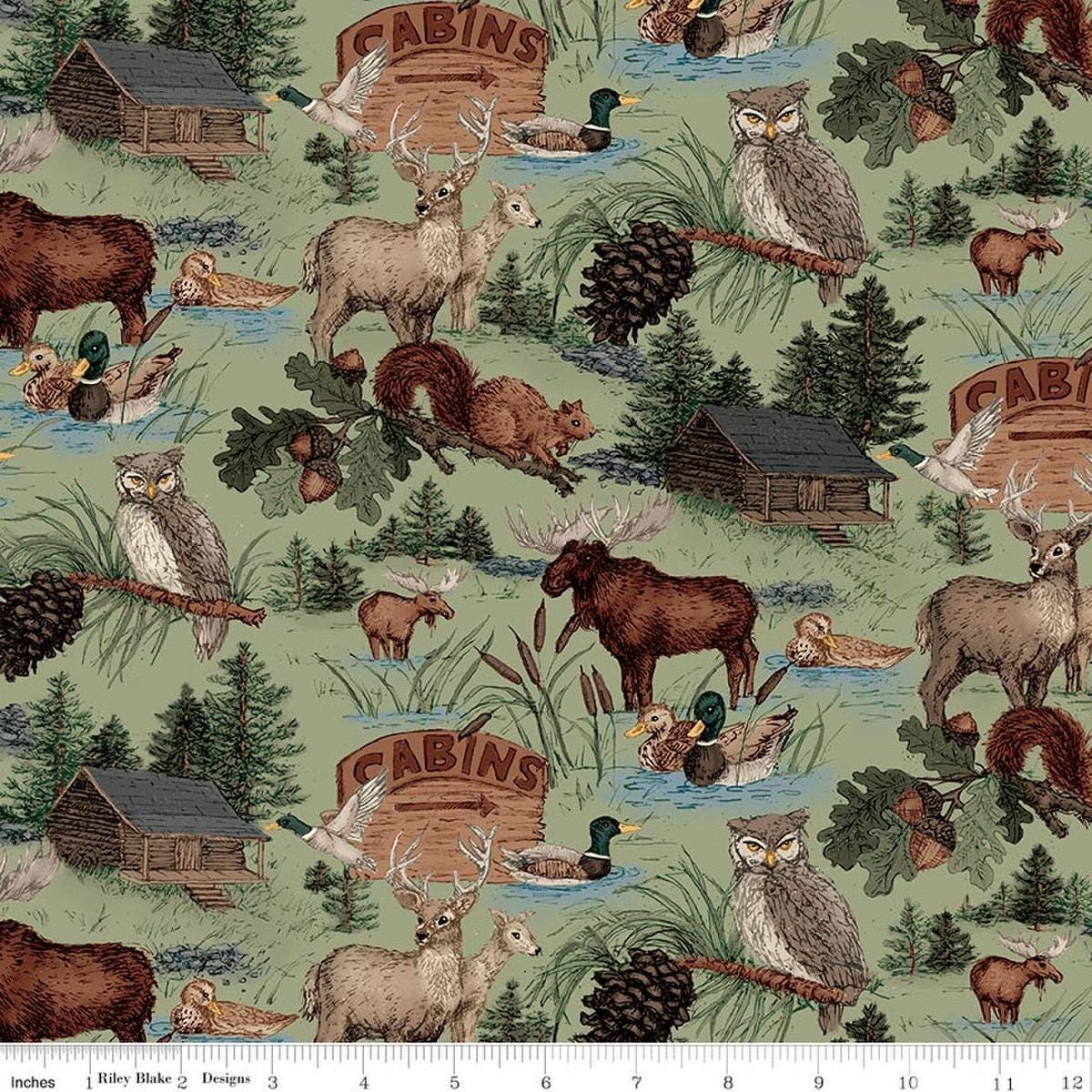 Image of Whispering Pines Main Green quilting cotton fabric by The RBD Designers for Riley Blake Designs. Features animals on a green background. Cute Little Fabric Shop.