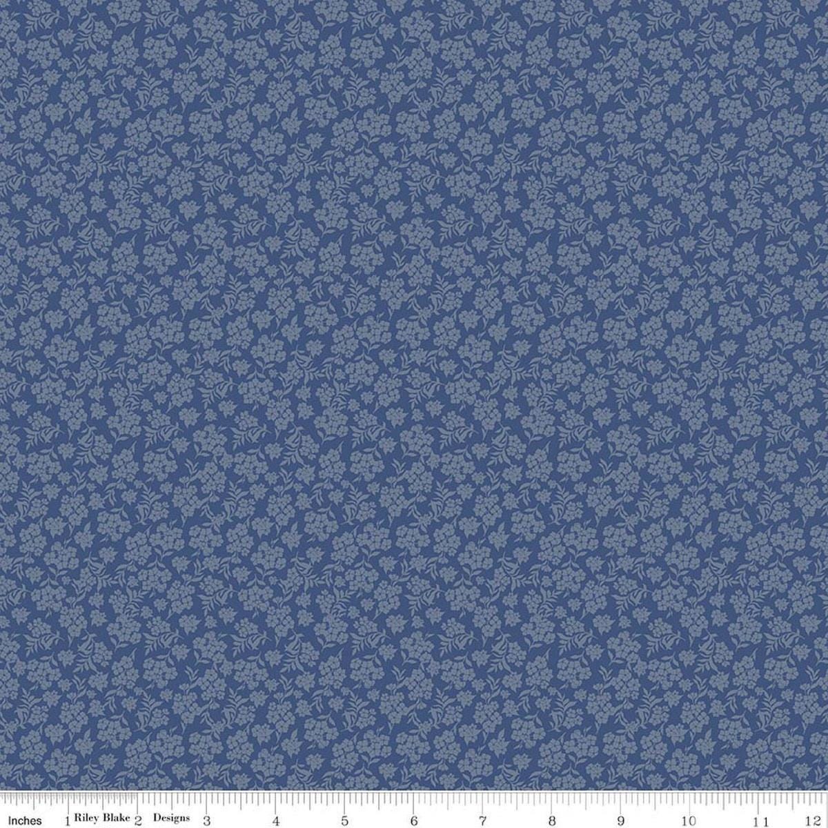 Image of Before the Blooms Viola Denim quilting cotton fabric by Danelys Sidron for Riley Blake Designs. Features flowers on a blue background. Cute Little Fabric Shop.