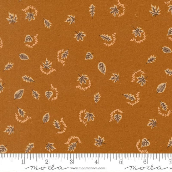 Image of Windfall Autumn Breeze Caramel quilting cotton fabric by Fancy That Design House for Moda Fabric. Features leaves on a brown background. Cute Little Fabric Shop.