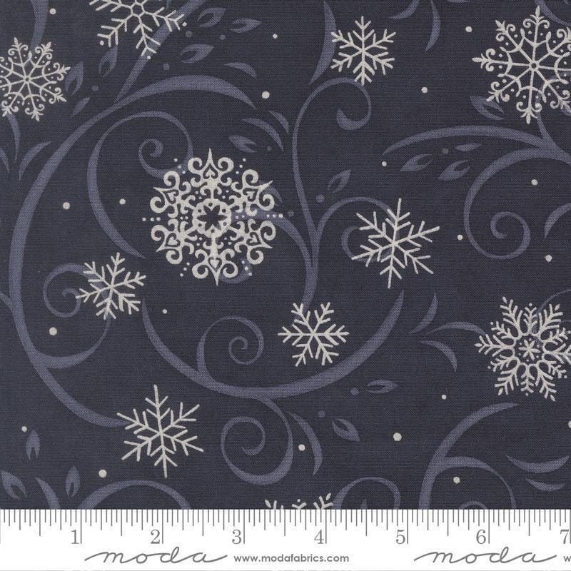 Image of When Snow Falls Swirling Snowflakes Night Sky quilting cotton fabric by Deb Strain for Moda Fabrics. Features snowflakes and swirls on a blue background. Cute Little Fabric Shop.