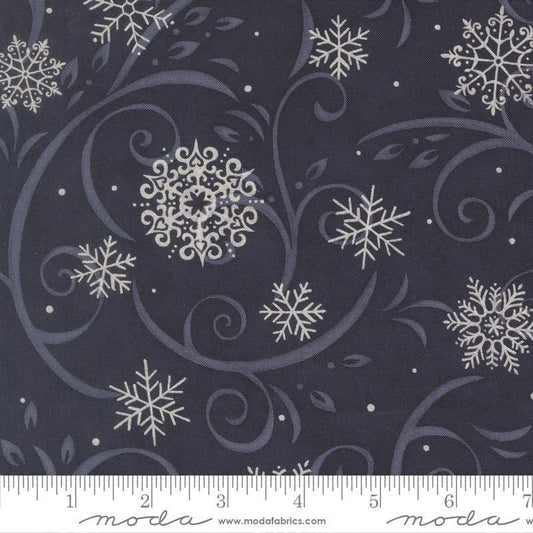 Image of When Snow Falls Swirling Snowflakes Night Sky quilting cotton fabric by Deb Strain for Moda Fabrics. Features snowflakes and swirls on a blue background. Cute Little Fabric Shop.