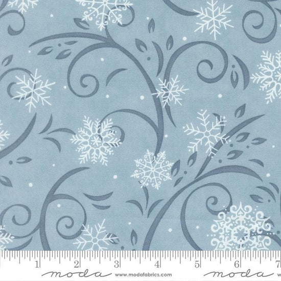 Image of When Snow Falls Swirling Snowflakes Winter Sky quilting cotton fabric by Deb Strain for Moda Fabrics. Features snowflakes and swirls on a blue background. Cute Little Fabric Shop.