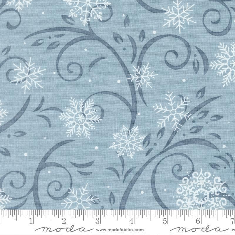 Image of When Snow Falls Swirling Snowflakes Winter Sky quilting cotton fabric by Deb Strain for Moda Fabrics. Features snowflakes and swirls on a blue background. Cute Little Fabric Shop.