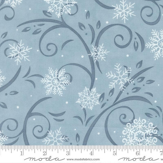 Image of When Snow Falls Swirling Snowflakes Winter Sky quilting cotton fabric by Deb Strain for Moda Fabrics. Features snowflakes and swirls on a blue background. Cute Little Fabric Shop.