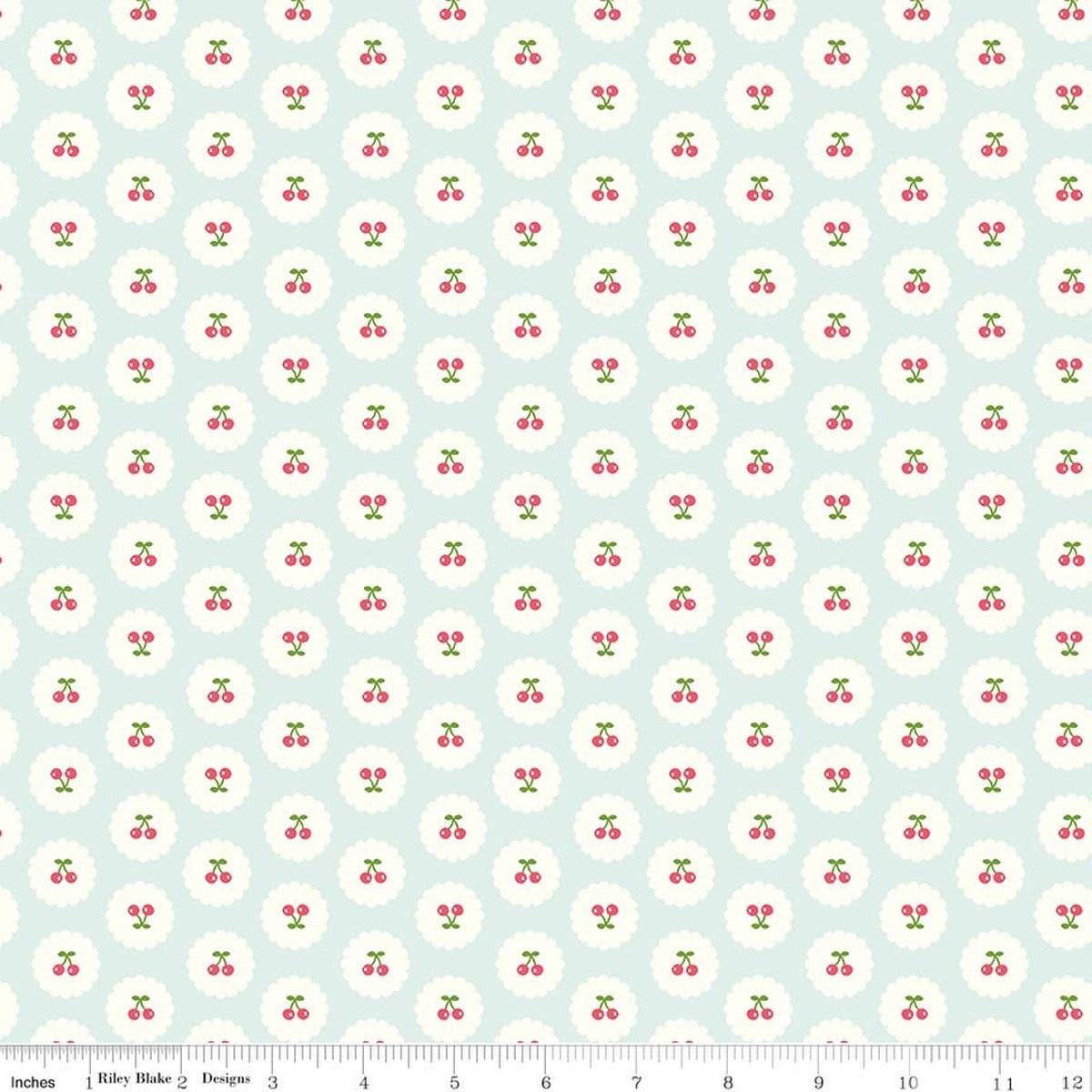 Image of Cotton Nook Cherries Bleached Denim quilting cotton fabric by Minki Kim for Riley Blake Designs. Features cherries on a blue background. Cute Little Fabric Shop.