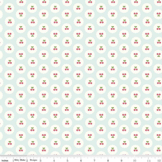 Image of Cotton Nook Cherries Bleached Denim quilting cotton fabric by Minki Kim for Riley Blake Designs. Features cherries on a blue background. Cute Little Fabric Shop.