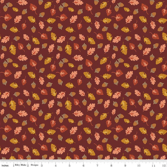 Image of Cozy Autumn Acorns & Oak Leaves Dark Rust quilting cotton fabric by Beverly McCullough for Riley Blake Designs. Features leaves and acorns on a brownish red background. Cute Little Fabric Shop.
