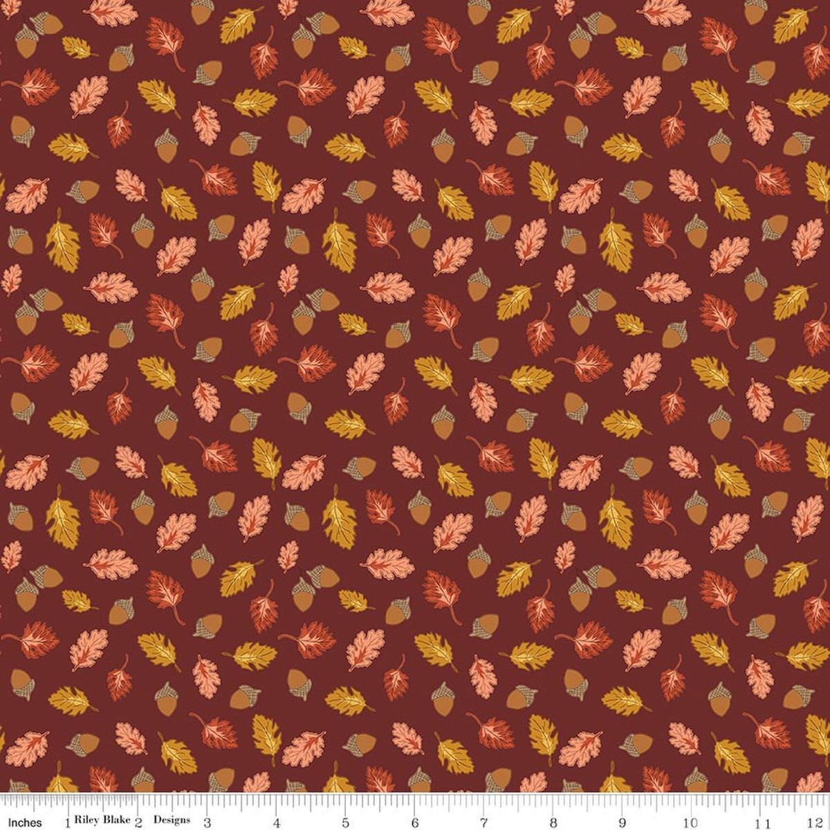Image of Cozy Autumn Acorns & Oak Leaves Dark Rust quilting cotton fabric by Beverly McCullough for Riley Blake Designs. Features leaves and acorns on a brownish red background. Cute Little Fabric Shop.