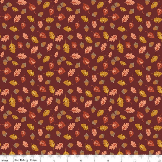 Image of Cozy Autumn Acorns & Oak Leaves Dark Rust quilting cotton fabric by Beverly McCullough for Riley Blake Designs. Features leaves and acorns on a brownish red background. Cute Little Fabric Shop.
