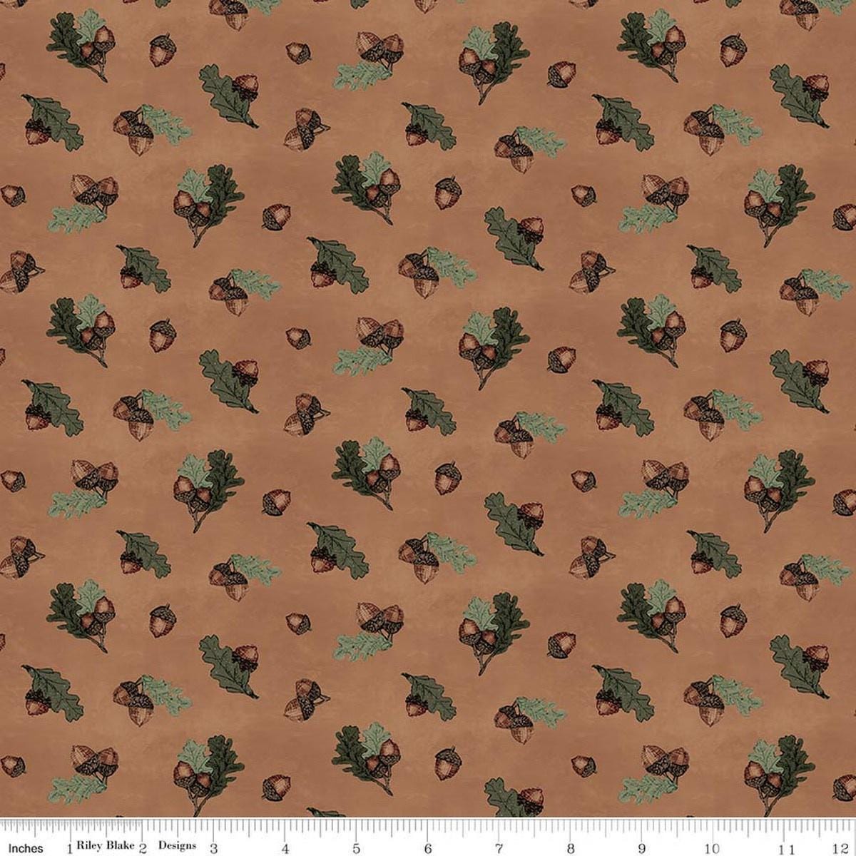 Image of Whispering Pines Acorns Brown quilting cotton fabric by The RBD Designers for Riley Blake Designs. Features acorns and leaves on a brown background. Cute Little Fabric Shop.