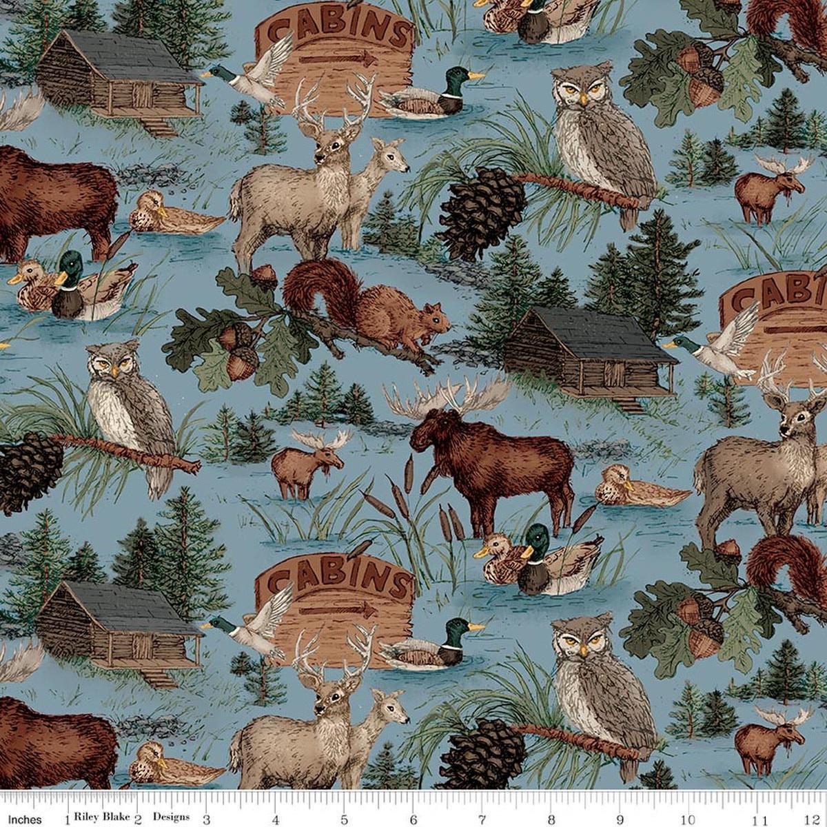 Image of Whispering Pines Main Blue quilting cotton fabric by The RBD Designers for Riley Blake Designs. Features animals on a blue background. Cute Little Fabric Shop.