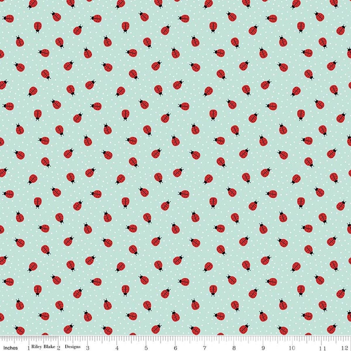 Image of Little Ladybug Ladybugs Blue quilting cotton fabric by Lori Whitlock for Riley Black Designs. Features ladybugs on a blue background. Cute Little Fabric Shop.