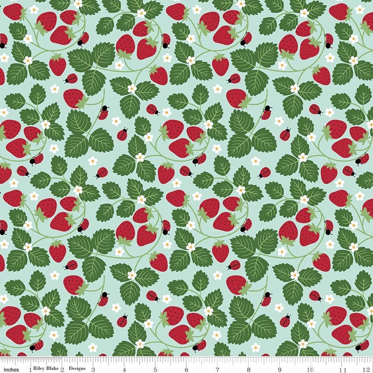 Image of Little Ladybug Strawberries Blue quilting cotton fabric by Lori Whitlock for Riley Black Designs. Features strawberries and leaves on a blue background. Cute Little Fabric Shop.