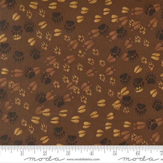 Image of Northwoods Lodge Animal Tracks Mud quilting cotton fabric by Deb Strain for Moda Fabrics. Features animal footprints on a brown background. Cute Little Fabric Shop.