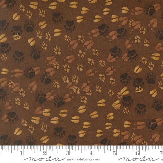 Image of Northwoods Lodge Animal Tracks Mud quilting cotton fabric by Deb Strain for Moda Fabrics. Features animal footprints on a brown background. Cute Little Fabric Shop.