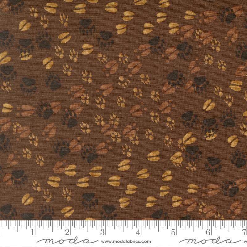 Image of Northwoods Lodge Animal Tracks Mud quilting cotton fabric by Deb Strain for Moda Fabrics. Features animal footprints on a brown background. Cute Little Fabric Shop.