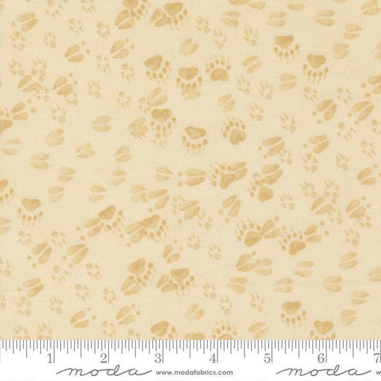 Image of Northwoods Lodge Animal Tracks Natural quilting cotton fabric by Deb Strain for Moda Fabrics. Features animal footprints on a cream background. Cute Little Fabric Shop.
