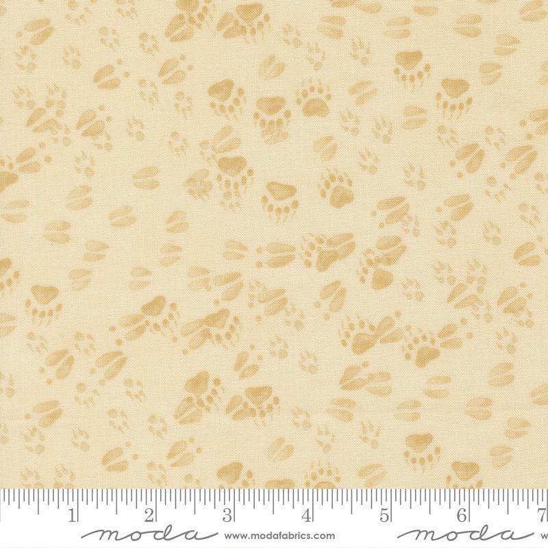 Image of Northwoods Lodge Animal Tracks Natural quilting cotton fabric by Deb Strain for Moda Fabrics. Features animal footprints on a cream background. Cute Little Fabric Shop.