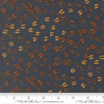 Image of Northwoods Lodge Animal Tracks Midnight quilting cotton fabric by Deb Strain for Moda Fabrics. Features animal footprints on a blue background. Cute Little Fabric Shop.