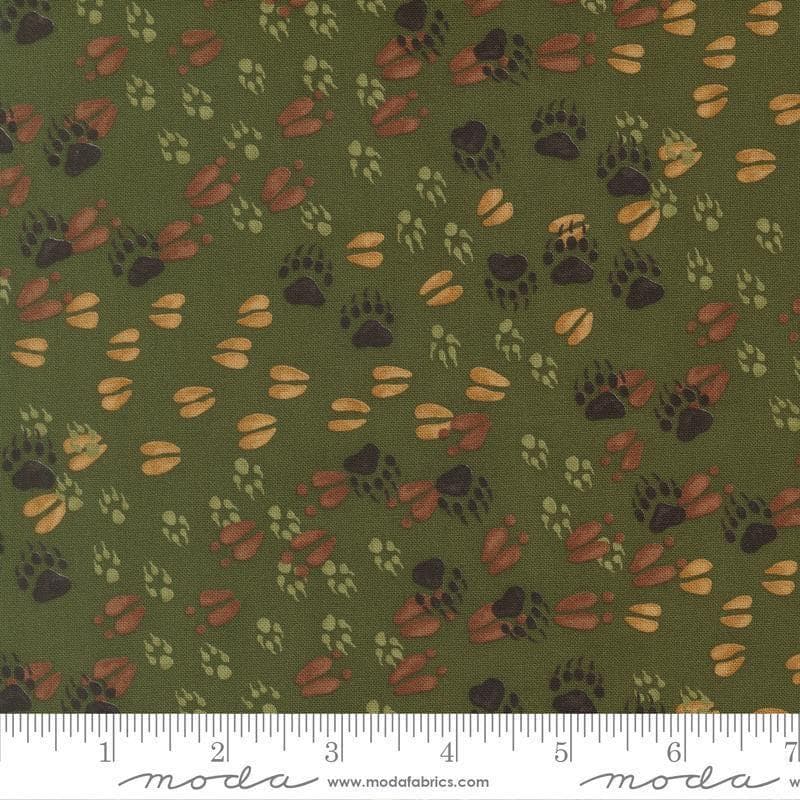 Image of Northwoods Lodge Animal Tracks Pine quilting cotton fabric by Deb Strain for Moda Fabrics. Features animal footprints on a green background. Cute Little Fabric Shop.
