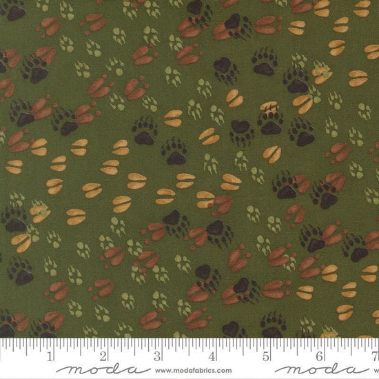 Image of Northwoods Lodge Animal Tracks Pine quilting cotton fabric by Deb Strain for Moda Fabrics. Features animal footprints on a green background. Cute Little Fabric Shop.