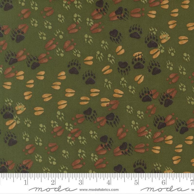 Image of Northwoods Lodge Animal Tracks Pine quilting cotton fabric by Deb Strain for Moda Fabrics. Features animal footprints on a green background. Cute Little Fabric Shop.
