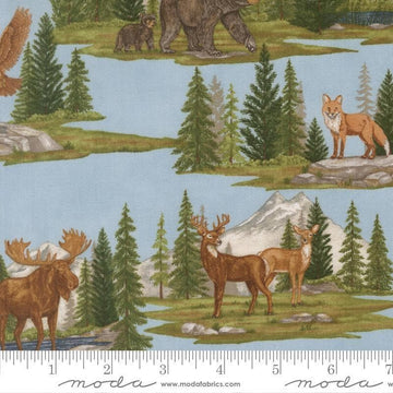 Image of Northwoods Lodge Allover Sky quilting cotton fabric by Deb Strain for Moda Fabrics. Features forests and animals on a blue background. Cute Little Fabric Shop.