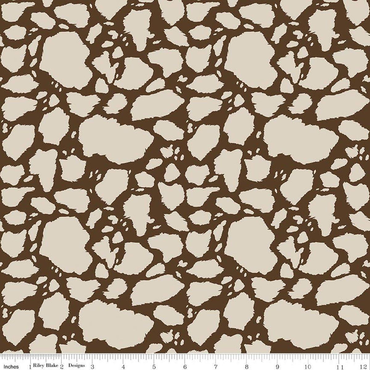 Image of The Homestead Cow Patches Tan quilting cotton fabric by Tara Reed for Riley Blake Designs. Features cow print on a brown background. Cute Little Fabric Shop.