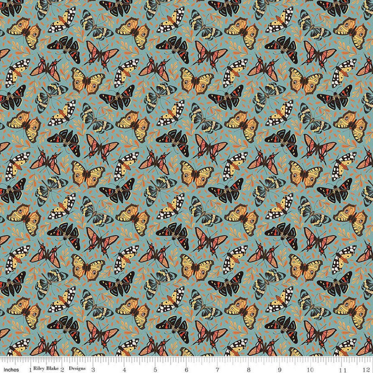 Image of Secret Garden Moths Wedgewood quilting cotton fabric by Amanda Castor for Riley Blake Designs. Features bugs on a blue background. Cute Little Fabric Shop.
