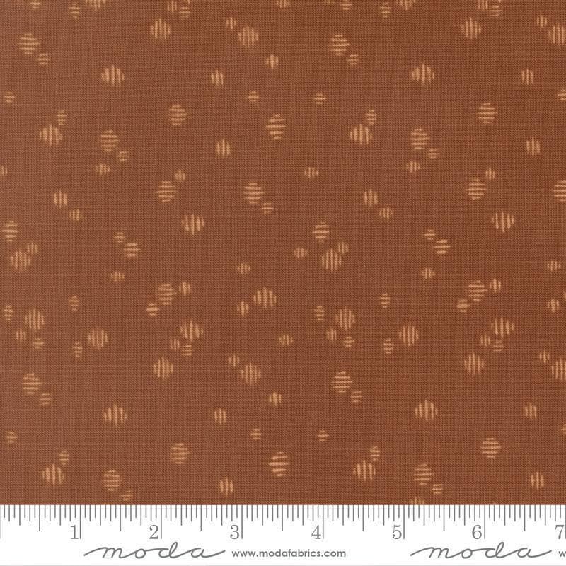 Image of Wellspring Dashed Dark Clay quilting cotton fabric by Fancy That Design House for Moda Fabrics. Features dots on a brown background. Cute Little Fabric Shop.