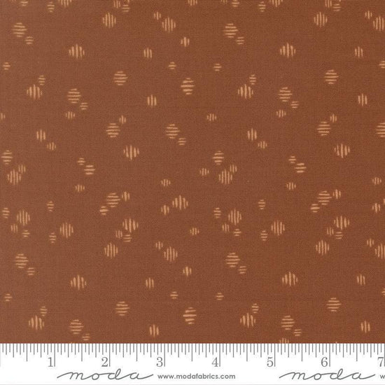 Image of Wellspring Dashed Dark Clay quilting cotton fabric by Fancy That Design House for Moda Fabrics. Features dots on a brown background. Cute Little Fabric Shop.