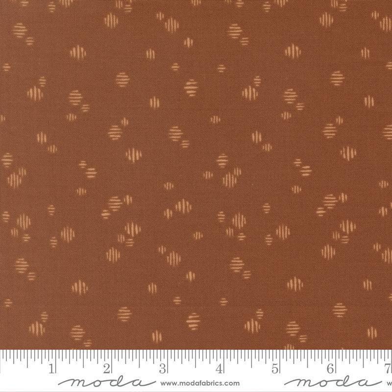 Image of Wellspring Dashed Dark Clay quilting cotton fabric by Fancy That Design House for Moda Fabrics. Features dots on a brown background. Cute Little Fabric Shop.