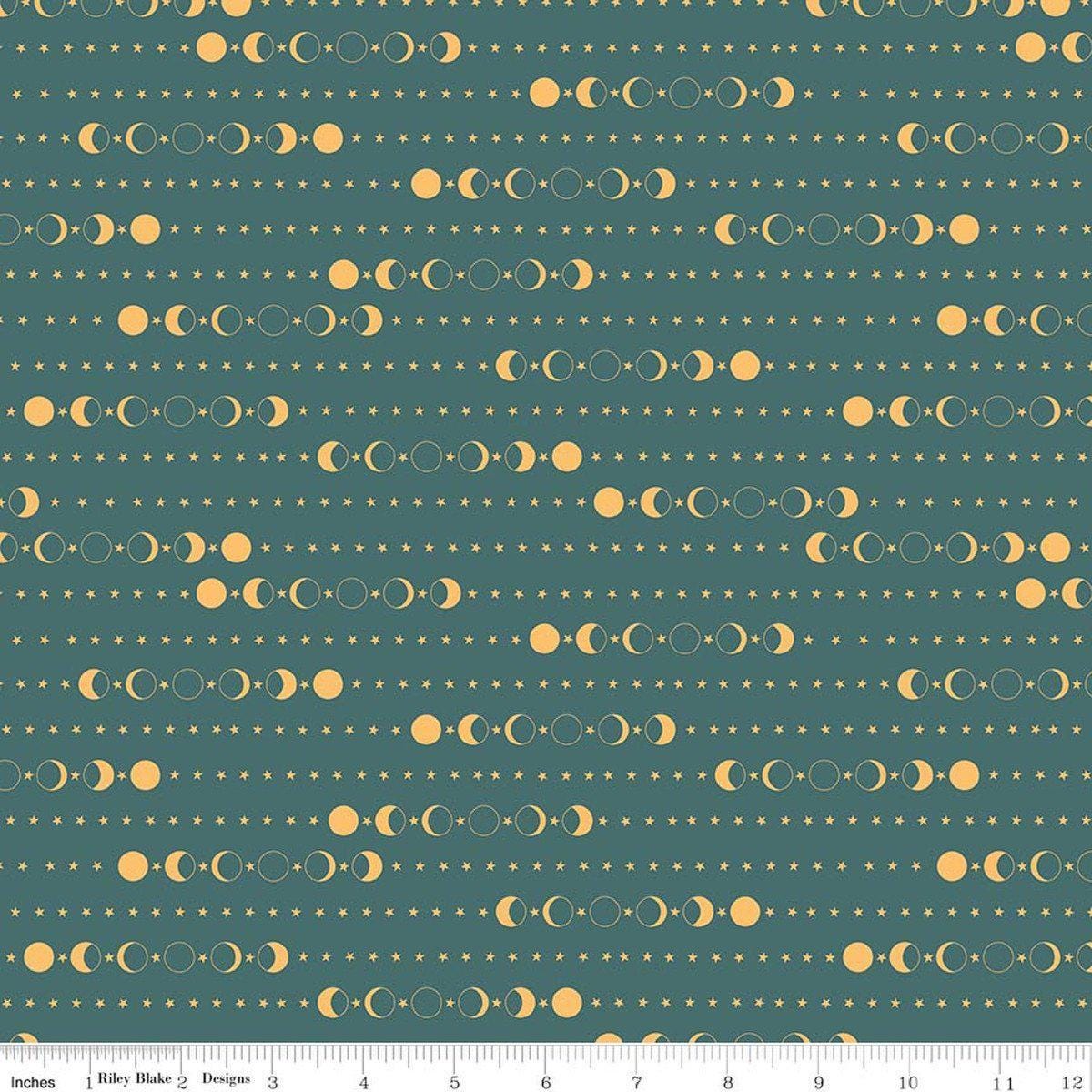 Image of Secret Garden Moon Phases Teal quilting cotton fabric by Amanda Castor for Riley Blake Designs. Features moons on a blue background. Cute Little Fabric Shop.