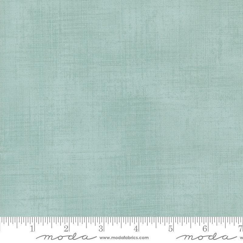 Image of Data Textured Solid Babbage quilting cotton fabric by Janet Clare for Moda Fabrics. Features printed solid texture on a blue background. Cute Little Fabric Shop.